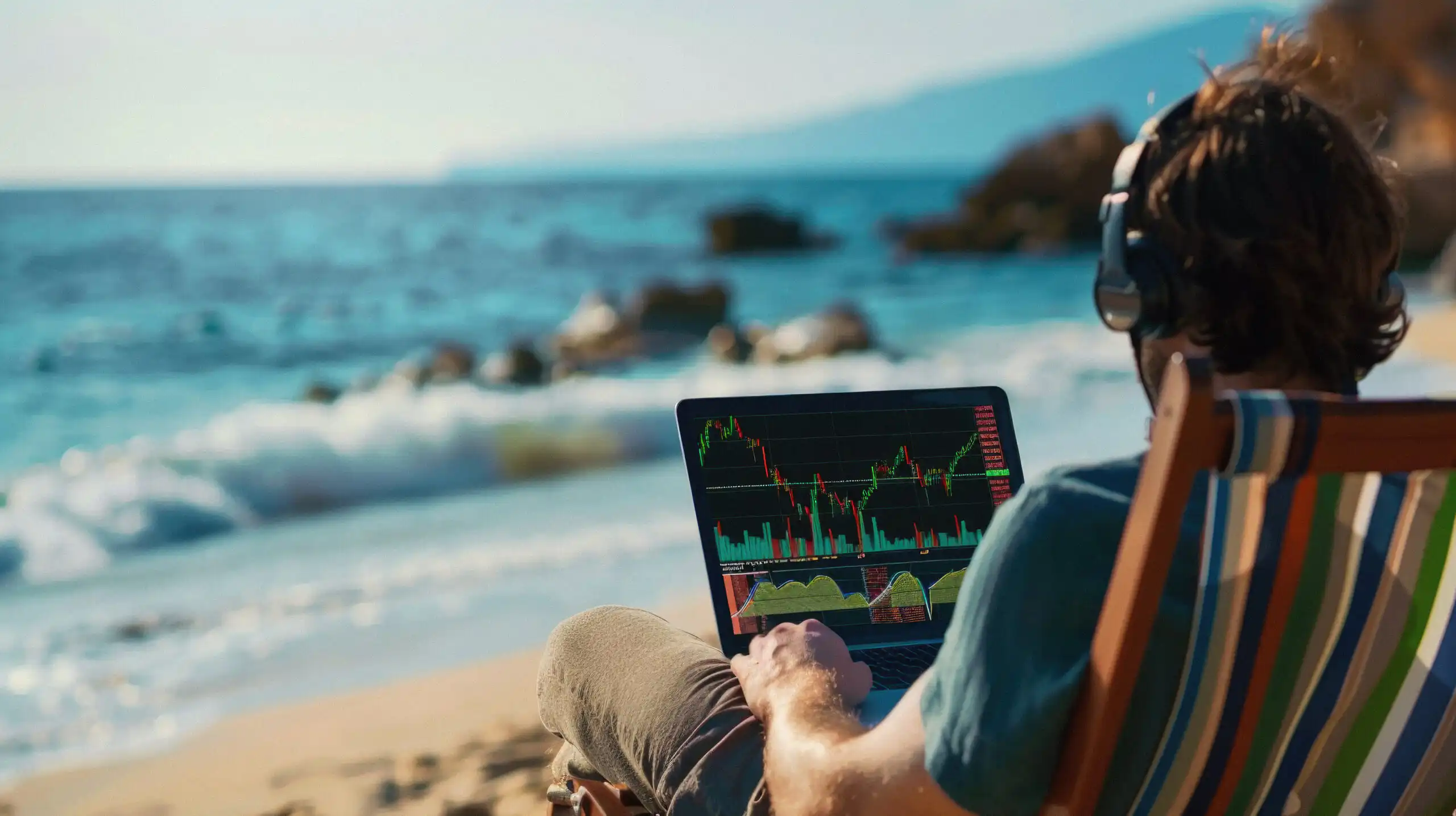 Successful rich stock trading investor, man trader or broker relaxing on summer beach at sea using laptop computer investing money in rising financial market analyzing charts on screen. Over shoulder.
