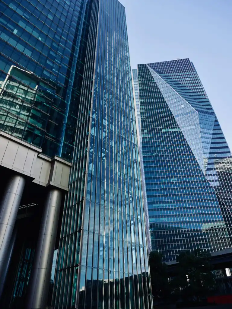 Tall glass office towers in a city financial district, symbolising audit market concentration among a small number of large firms in Australia